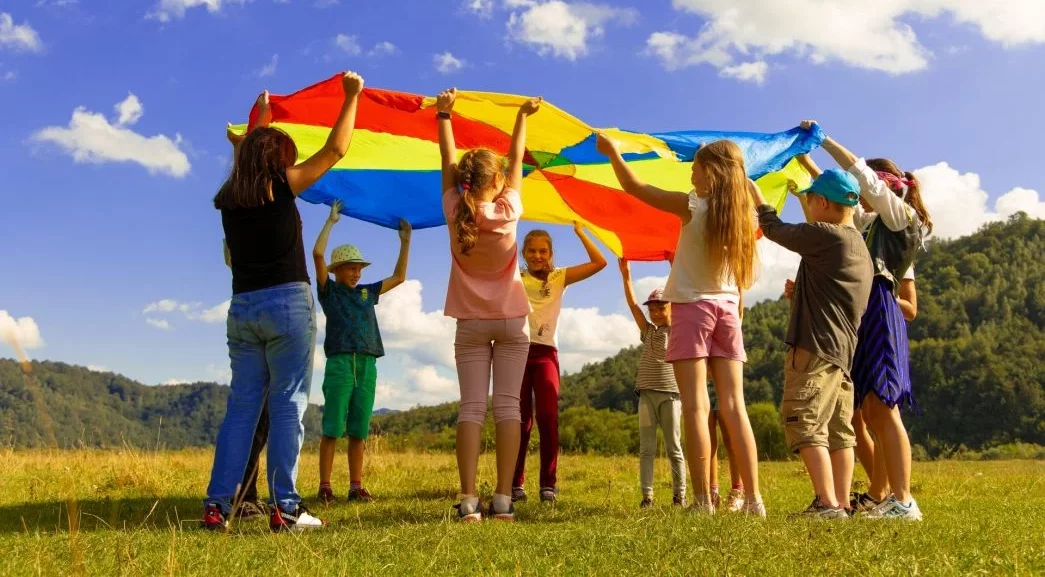 Holding a Coloured Kite in a Field