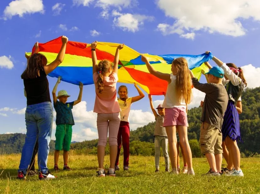Holding a Coloured Kite in a Field