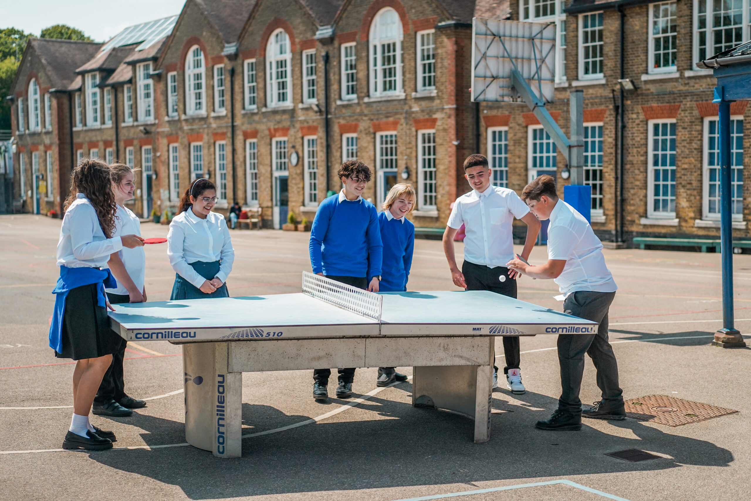 Children playing ping pong.
