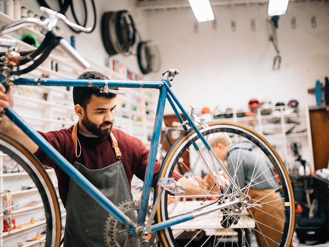 Employee Fixing a Bike in a Bike Store