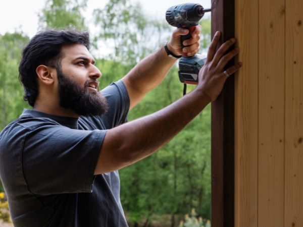 Man drilling into a wall